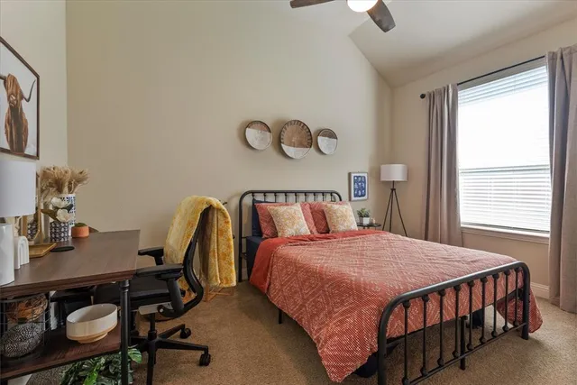 a bedroom with a bed and a table