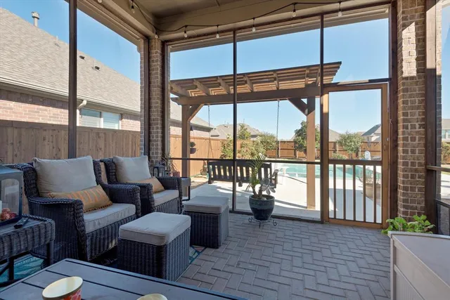 a living room with furniture and a floor to ceiling window