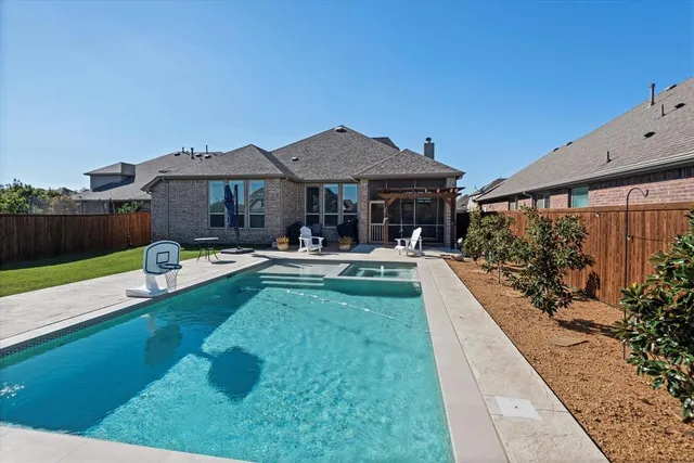 a swimming pool view with a seating space