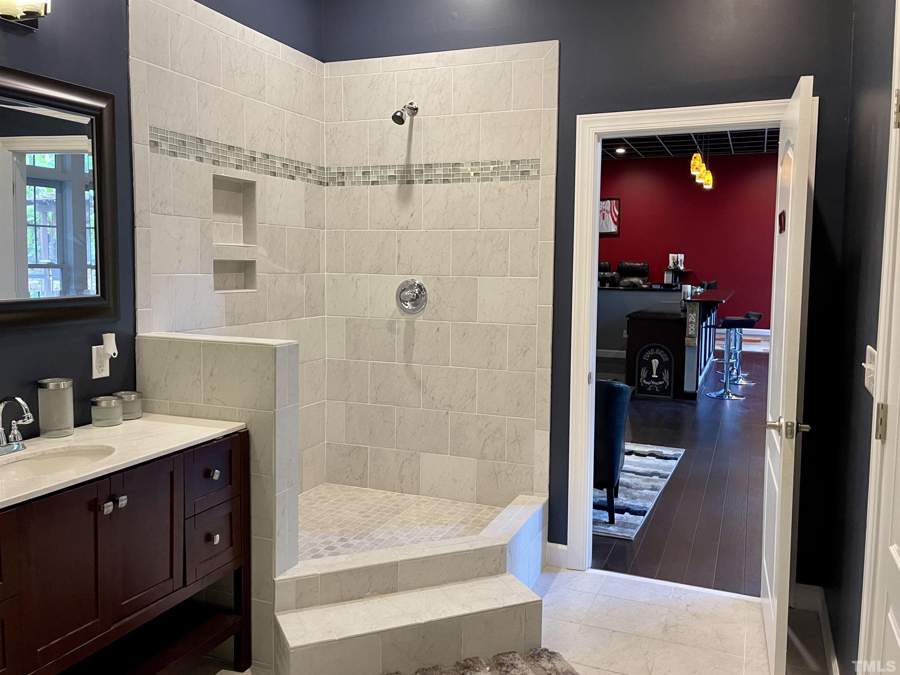 3005 London Bell Drive Raleigh, NC 27614 - Photo 11 of 73 a bathroom with a sink a mirror and a shower