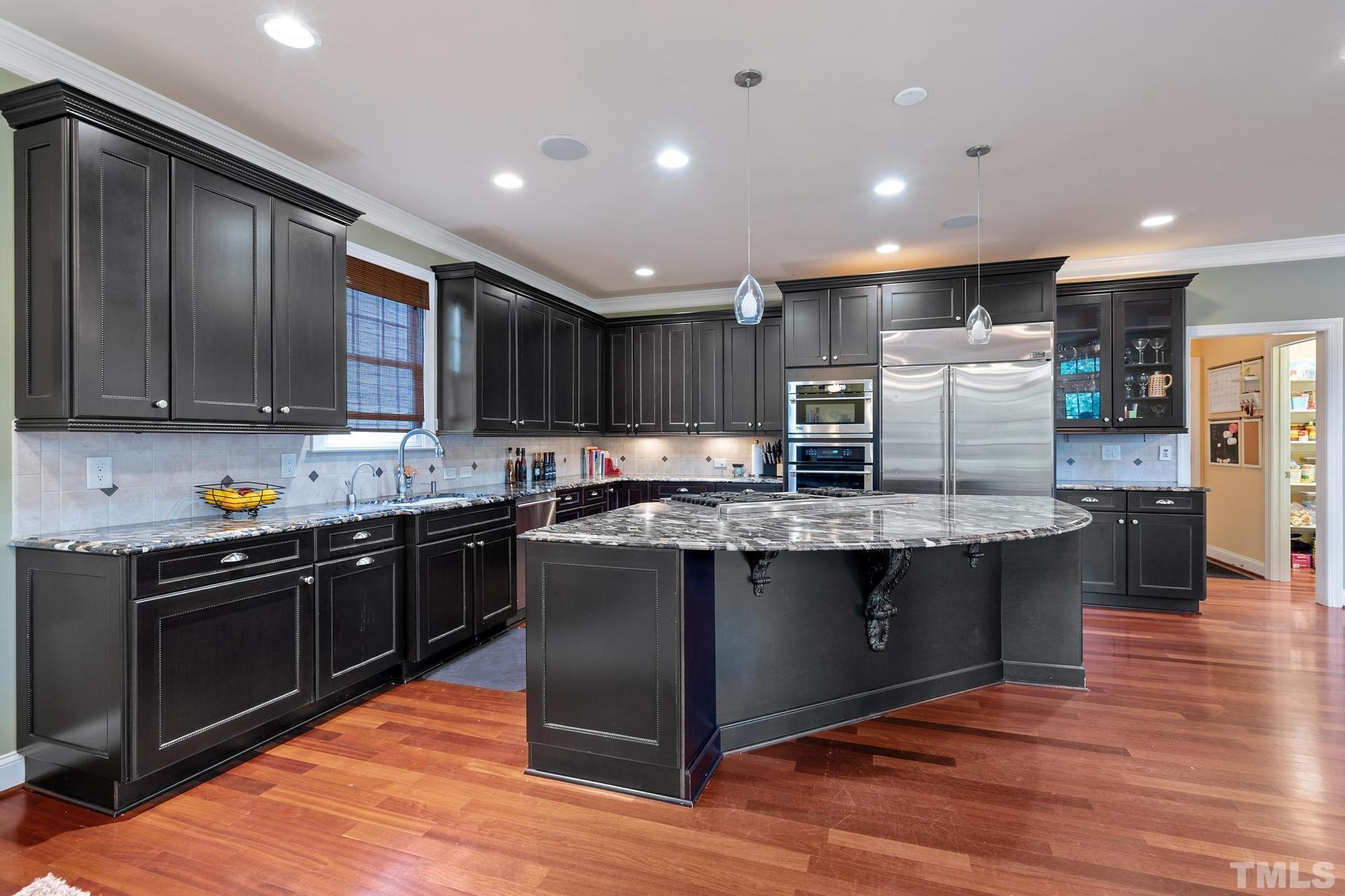 3005 London Bell Drive Raleigh, NC 27614 - Photo 19 of 73 a kitchen with stainless steel appliances granite countertop wooden cabinets a refrigerator a stove a sink and dishwasher with wooden floor