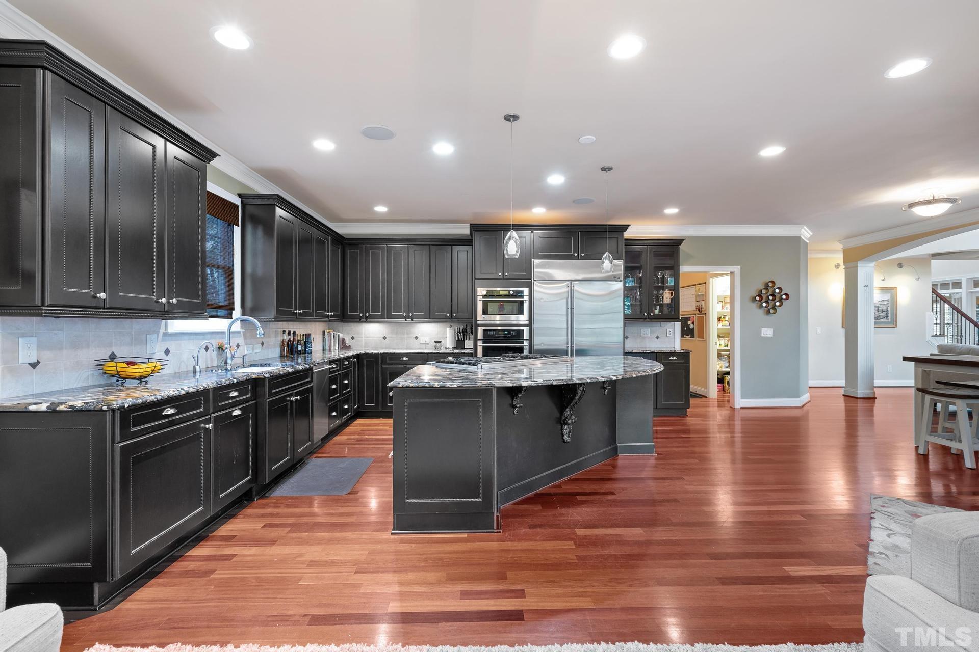 3005 London Bell Drive Raleigh, NC 27614 - Photo 20 of 73 a kitchen with stainless steel appliances granite countertop wooden cabinets a refrigerator a stove a sink and a oven