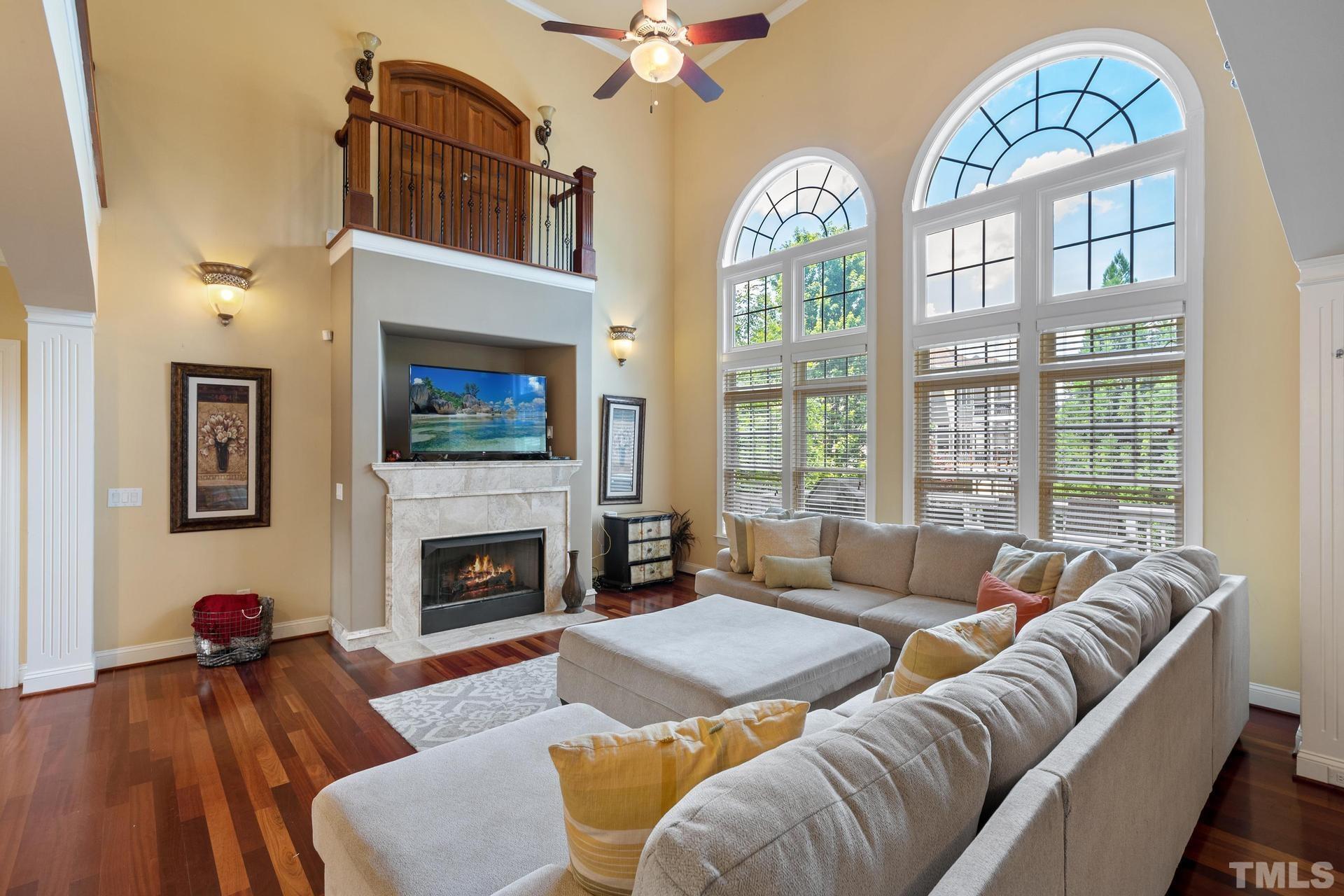 3005 London Bell Drive Raleigh, NC 27614 - Photo 28 of 73 a living room with furniture a fireplace and a large window
