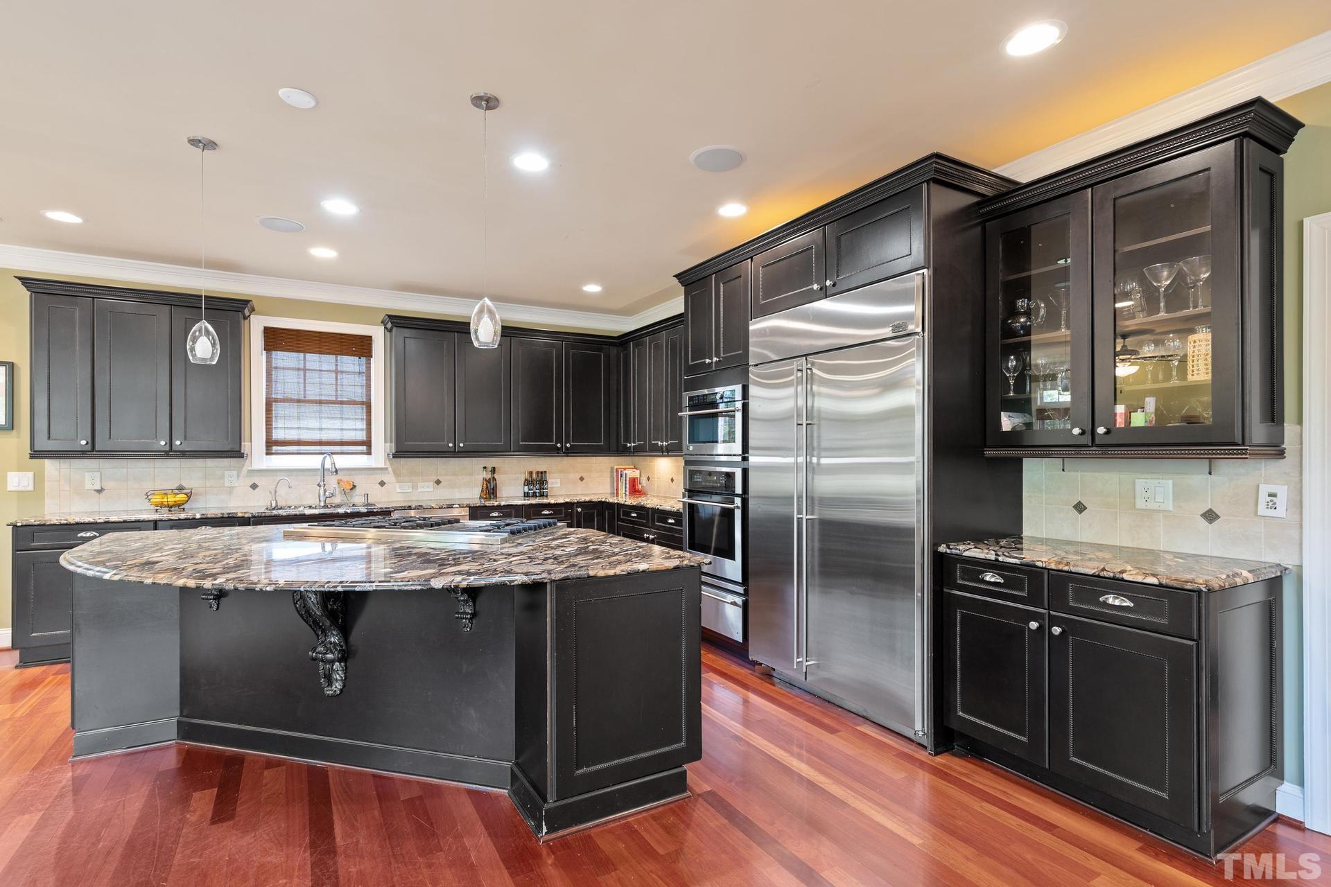 3005 London Bell Drive Raleigh, NC 27614 - Photo 32 of 73 a kitchen with stainless steel appliances granite countertop a stove a refrigerator and a microwave