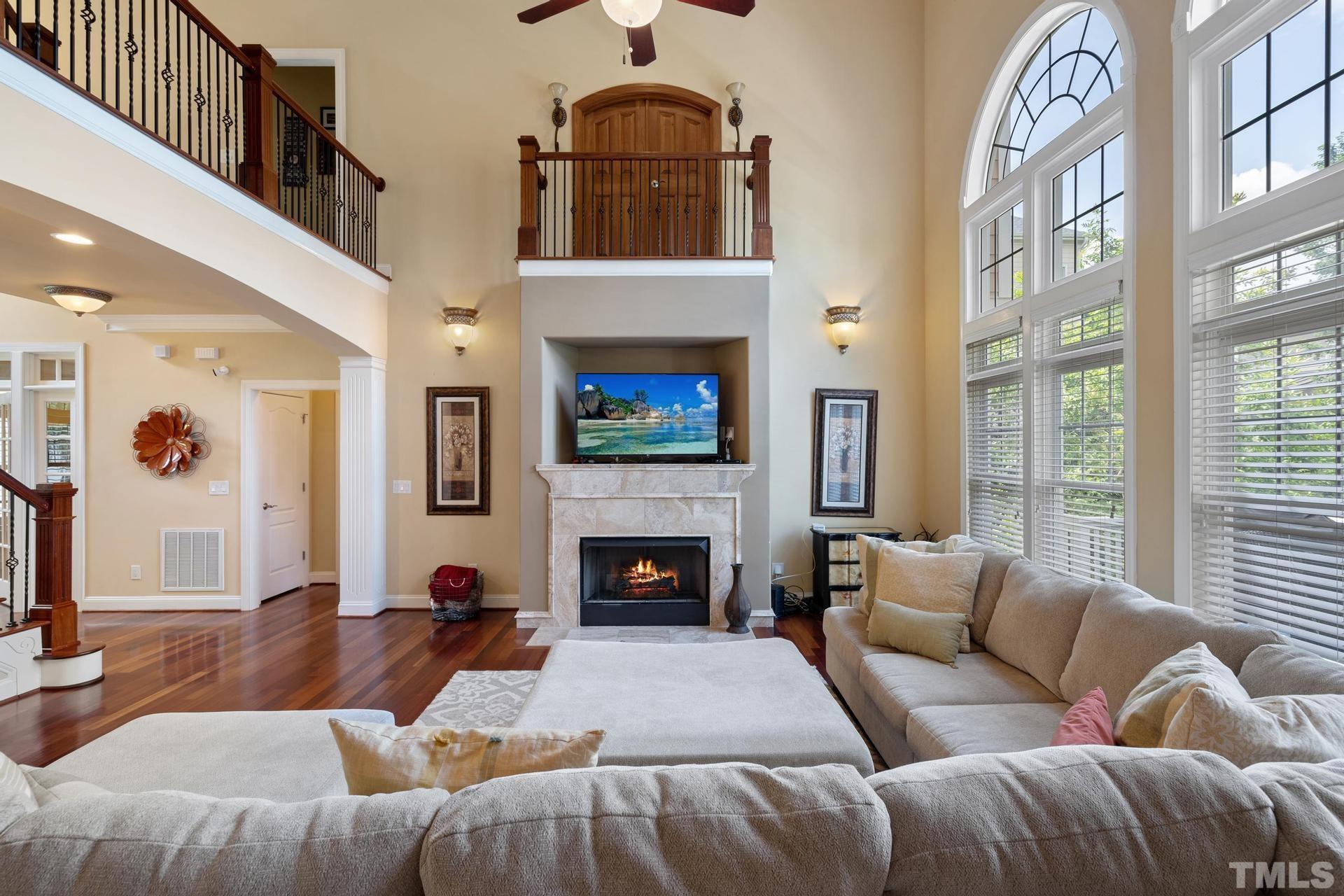 3005 London Bell Drive Raleigh, NC 27614 - Photo 37 of 73 a living room with furniture a fireplace and a large window