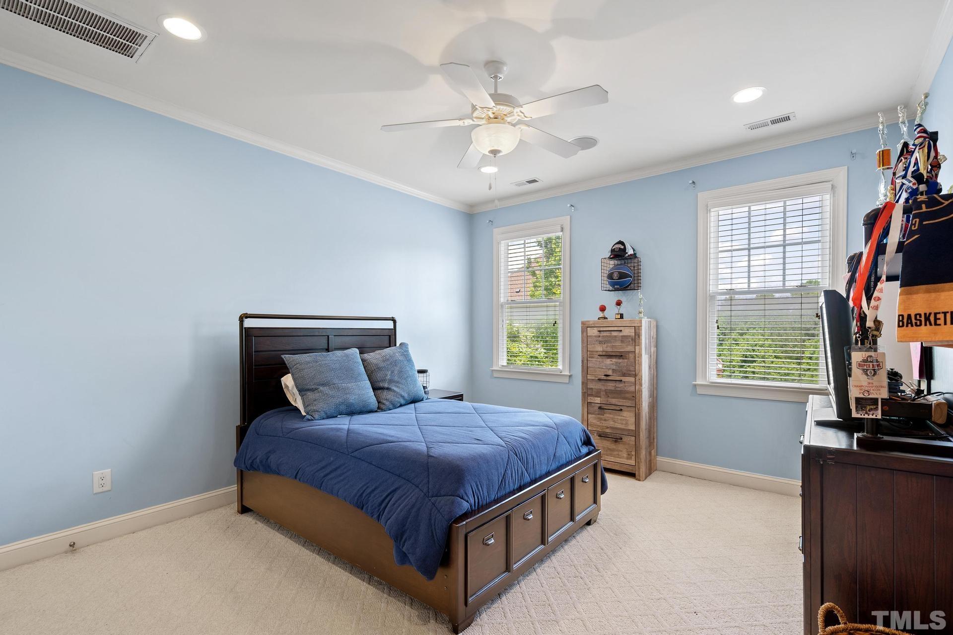 3005 London Bell Drive Raleigh, NC 27614 - Photo 38 of 73 a bedroom with a bed and a large window with a bookshelf