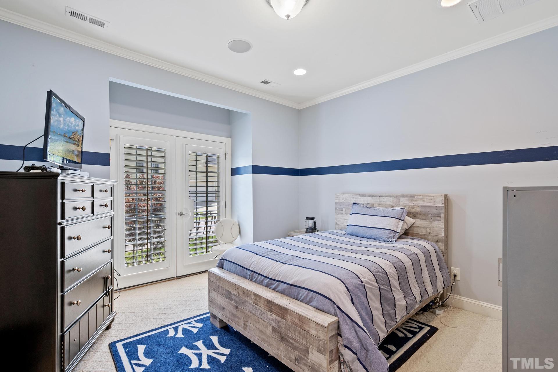 3005 London Bell Drive Raleigh, NC 27614 - Photo 41 of 73 a bedroom with a bed and flat screen tv