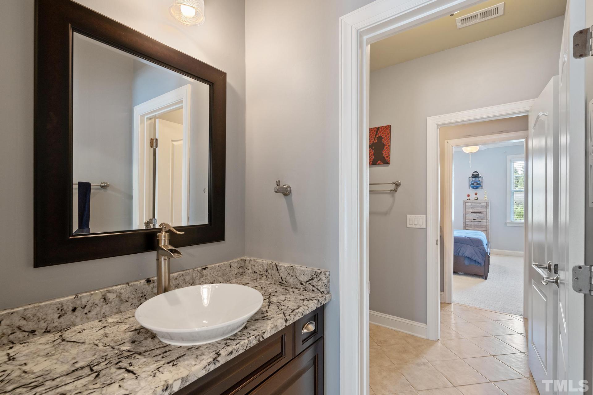 3005 London Bell Drive Raleigh, NC 27614 - Photo 43 of 73 a bathroom with a granite countertop sink and a mirror