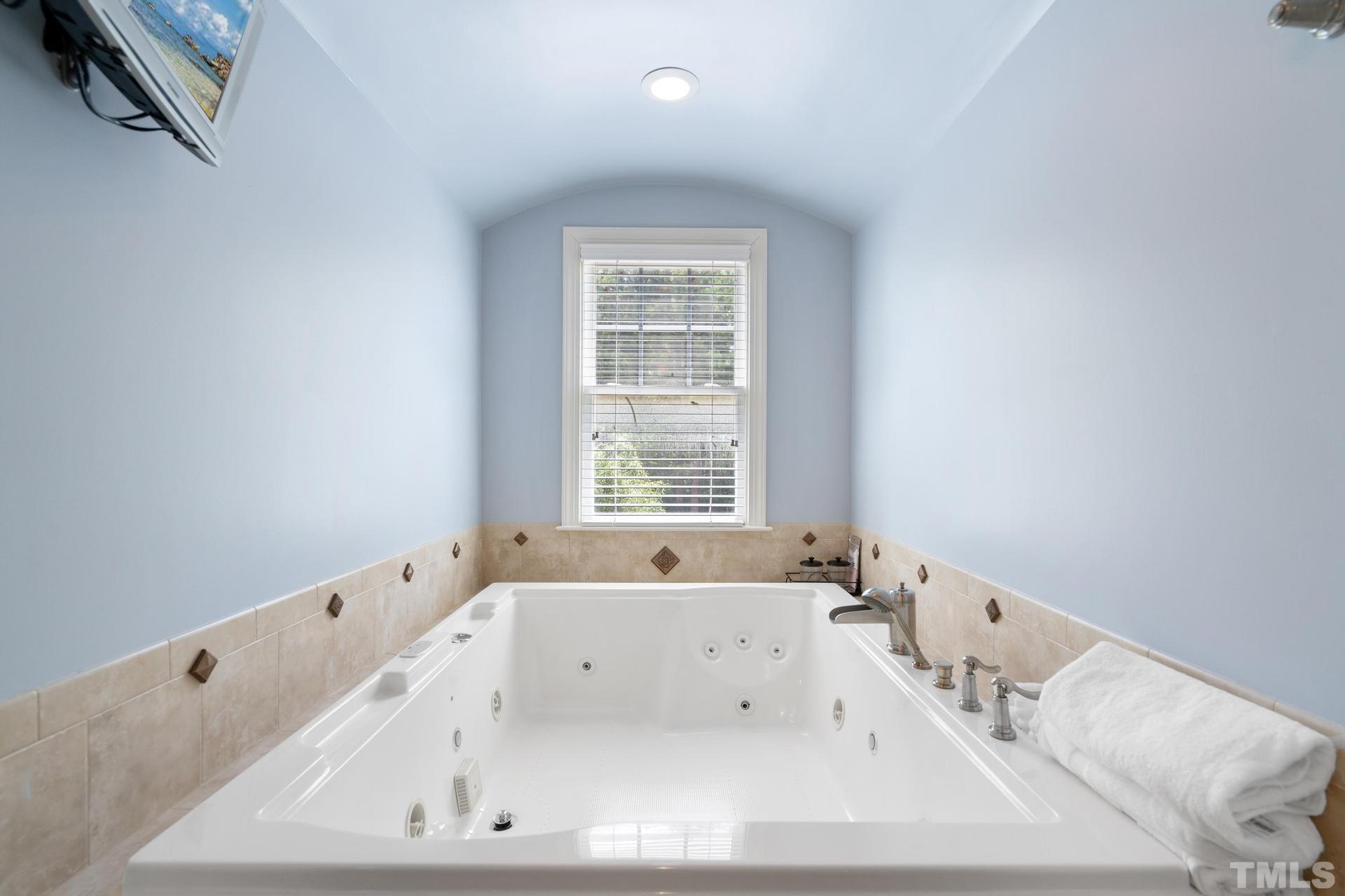 3005 London Bell Drive Raleigh, NC 27614 - Photo 45 of 73 a bath tub sitting in a bathroom next to a window