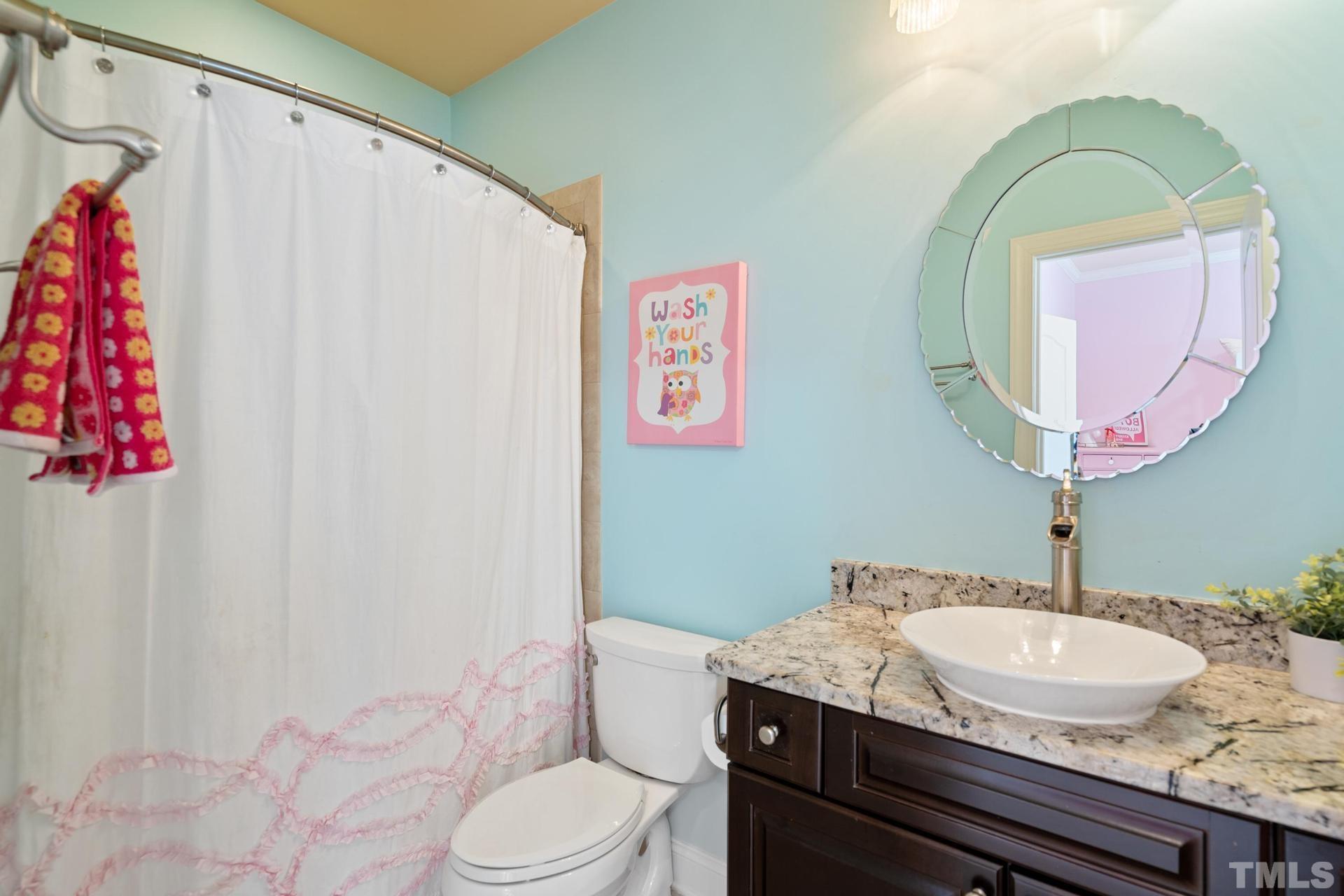 3005 London Bell Drive Raleigh, NC 27614 - Photo 47 of 73 a bathroom with a granite countertop sink and a mirror