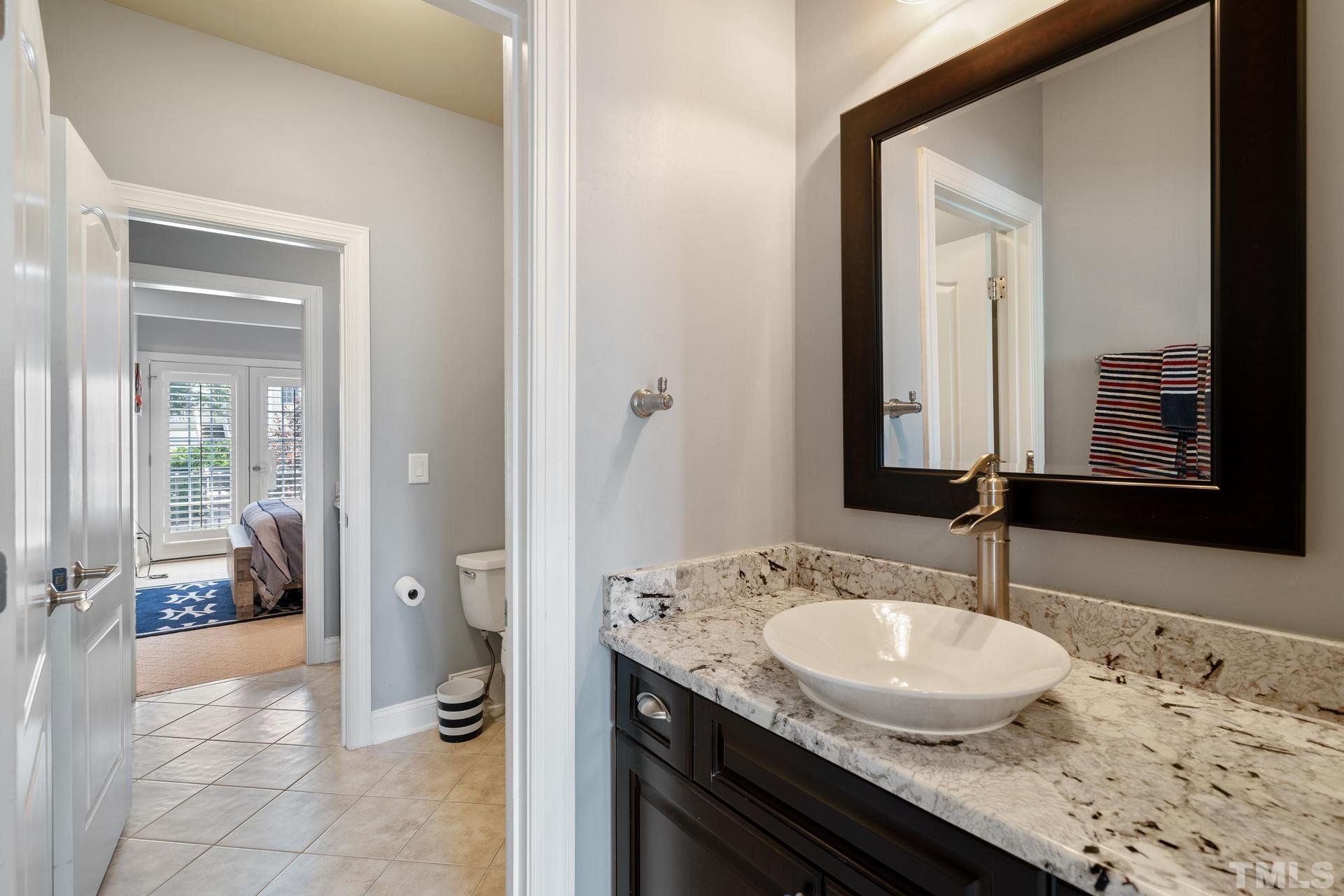 3005 London Bell Drive Raleigh, NC 27614 - Photo 51 of 73 a bathroom with a granite countertop sink a mirror and a bathtub