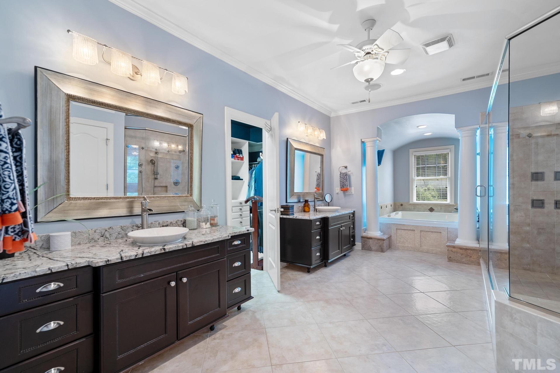 3005 London Bell Drive Raleigh, NC 27614 - Photo 52 of 73 a spacious bathroom with a granite countertop sink mirror and a bathtub