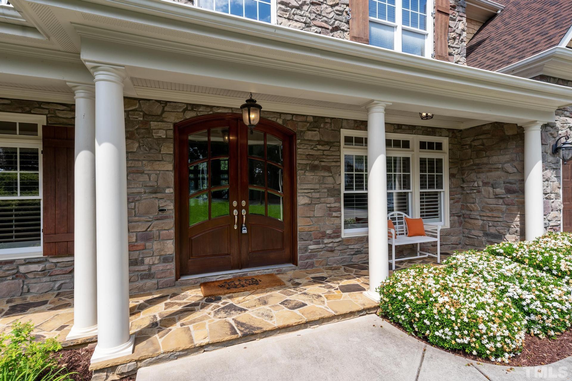 3005 London Bell Drive Raleigh, NC 27614 - Photo 73 of 73 front view of a house with a large window and a potted plant