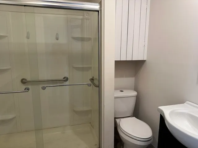 a white toilet sitting next to a bathroom sink