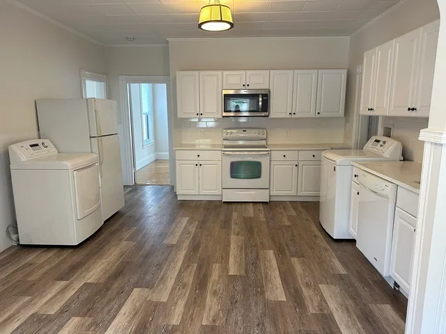 a kitchen with appliances cabinets and a sink