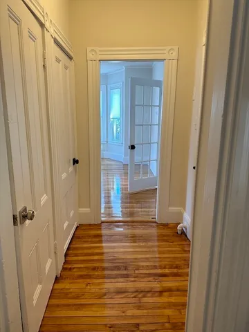 a view of a bathroom with wooden floor and a shower