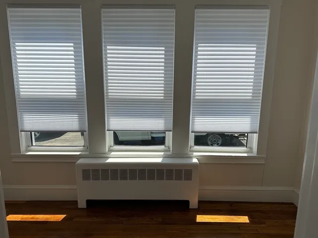 a room with wooden floor and a window