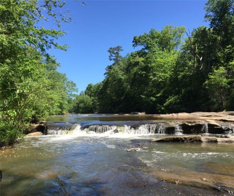 4523 Riverside Drive Southwest Lilburn, GA 30047 - Photo 9 of 12 a view of a lake with houses