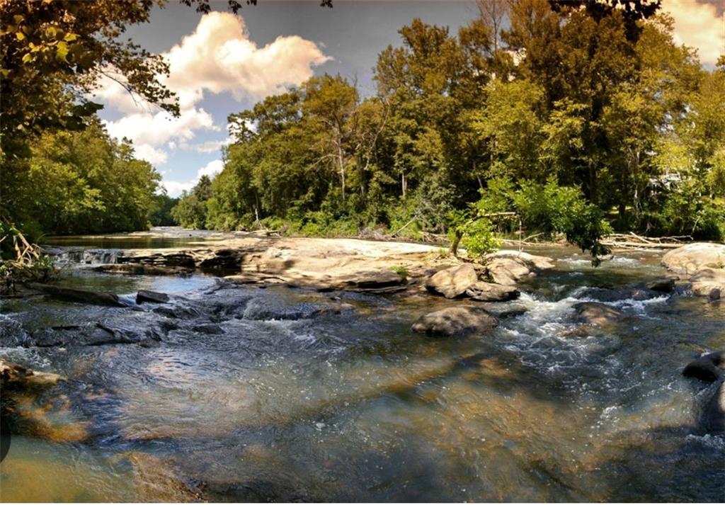 4523 Riverside Drive Southwest Lilburn, GA 30047 - Photo 10 of 12 a view of a lake with trees