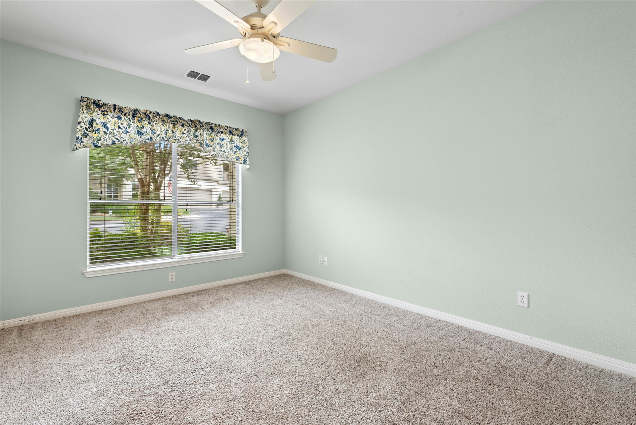 7500 Shadowridge Run, Unit 34 Austin, TX 78749 - Photo 16 of 27 an empty room with a window and a fan