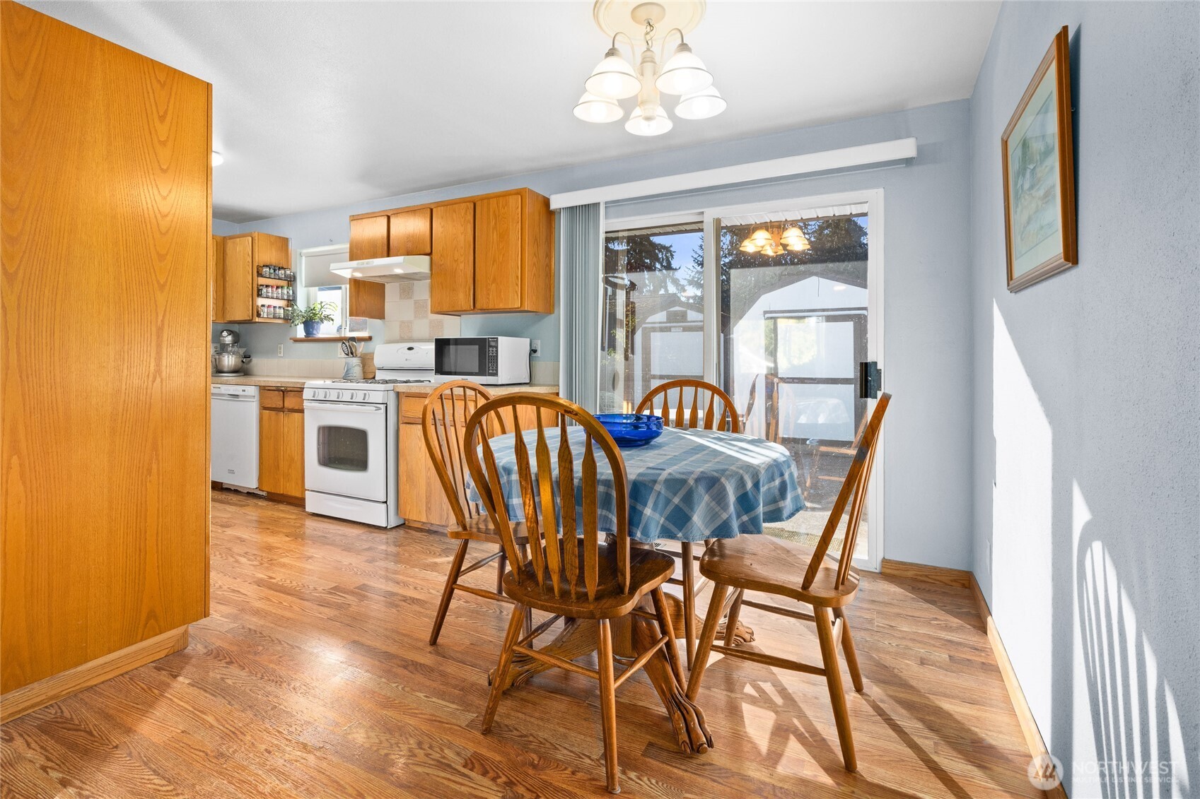 6202 224th Street Southwest Mountlake Terrace, WA 98043 - Photo 6 of 23 a view of a dining room with furniture a chandelier and wooden floor