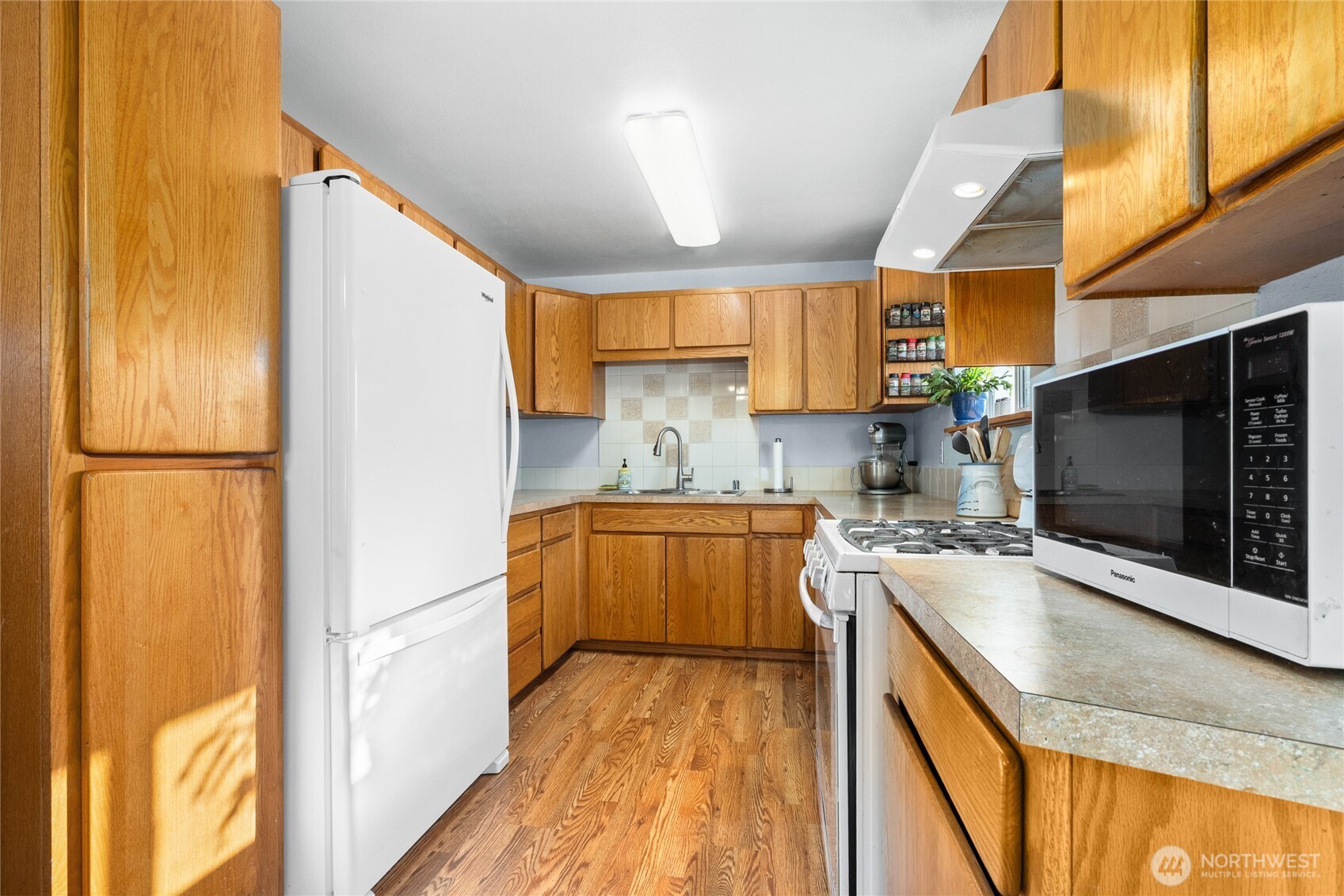 6202 224th Street Southwest Mountlake Terrace, WA 98043 - Photo 7 of 23 a kitchen with stainless steel appliances granite countertop a sink stove and refrigerator