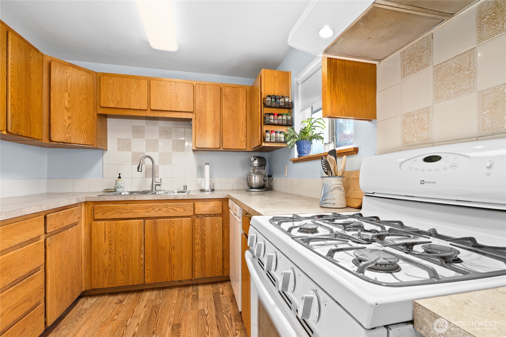 6202 224th Street Southwest Mountlake Terrace, WA 98043 - Photo 9 of 23 a kitchen with a sink stove and cabinets