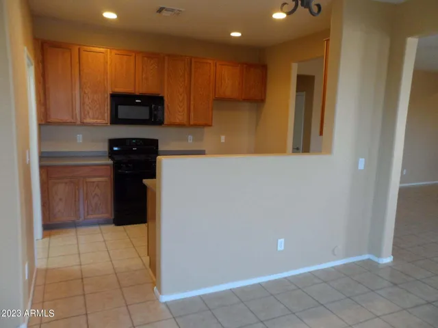 a kitchen with granite countertop a stove and a microwave