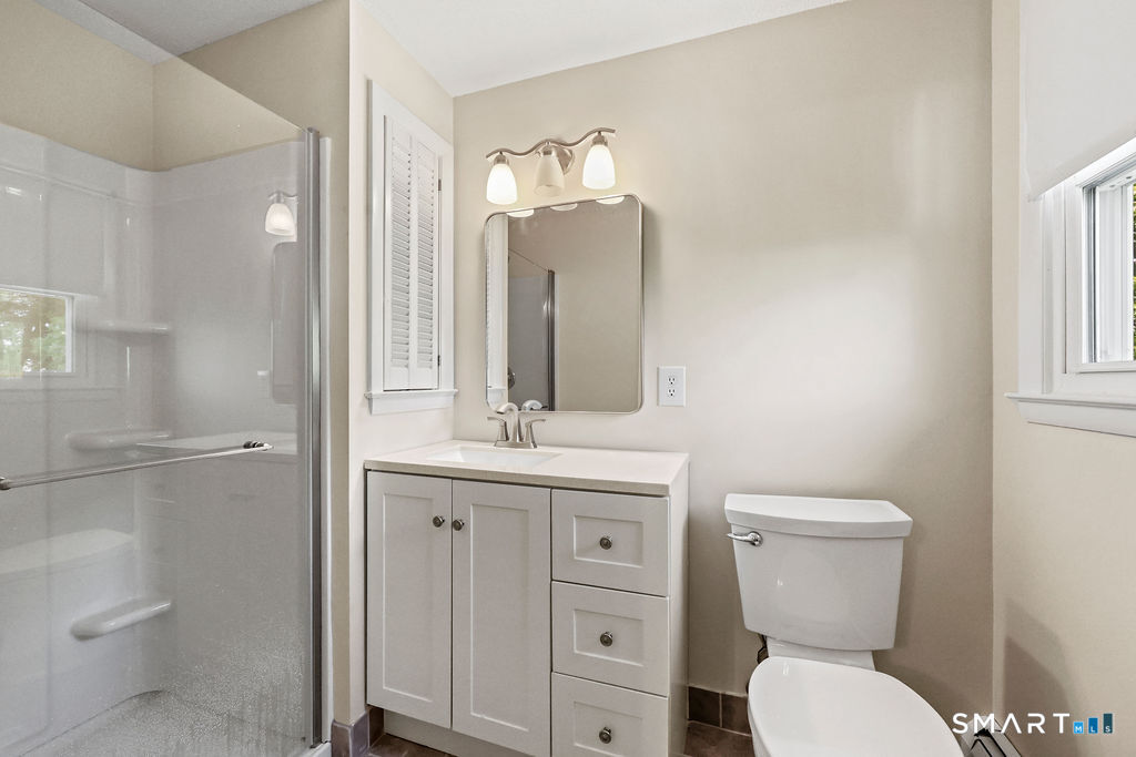 142 Wolcott Hill Road Wethersfield, CT 06109 - Photo 14 of 29 a bathroom with a toilet sink and mirror