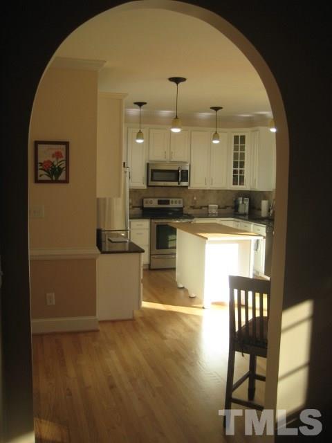 6613 Mafolie Court Raleigh, NC 27613 - Photo 8 of 8 a kitchen with stainless steel appliances granite countertop a stove and a refrigerator