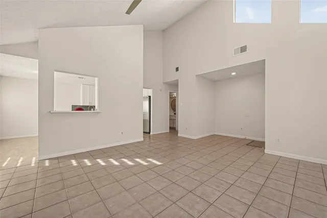 a kitchen with stainless steel appliances granite countertop a refrigerator a stove and a sink