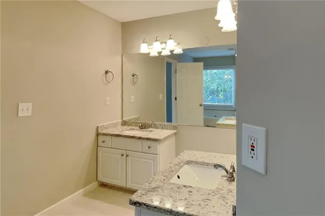 a bathroom with a sink vanity and a mirror