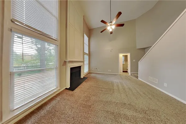 a view of a livingroom with a ceiling fan and window