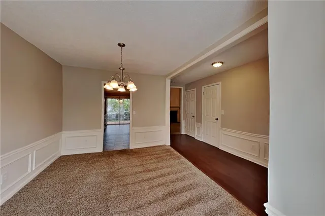 a view of an empty room with window and cabinet
