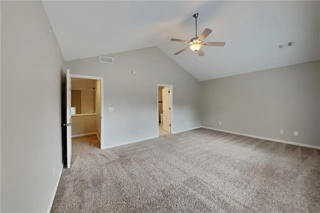 a view of a livingroom with a ceiling fan and window