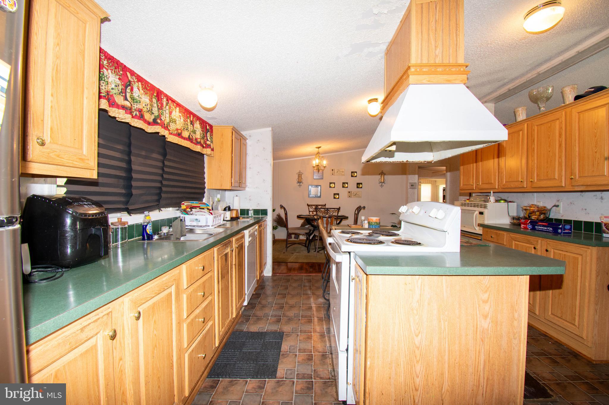 8791 Menokin Road Montross, VA 22520 - Photo 17 of 37 a kitchen with stainless steel appliances granite countertop a sink and a stove