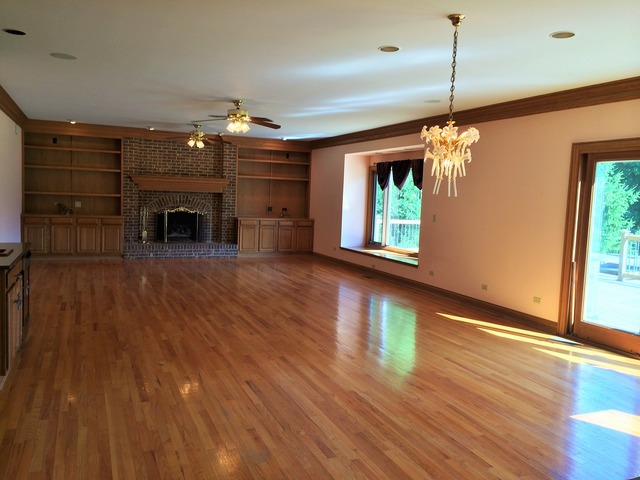 988 Plum Tree Road Fox River Grove, IL 60021 - Photo 3 of 25 a view of a livingroom with a fireplace and window