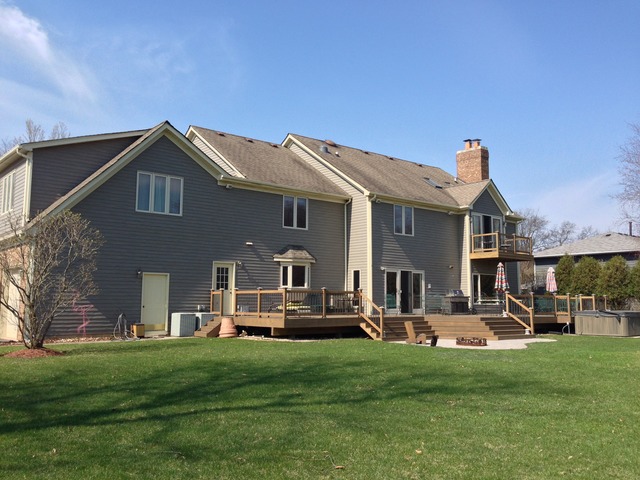 988 Plum Tree Road Fox River Grove, IL 60021 - Photo 22 of 25 a front view of a house with a garden and plants