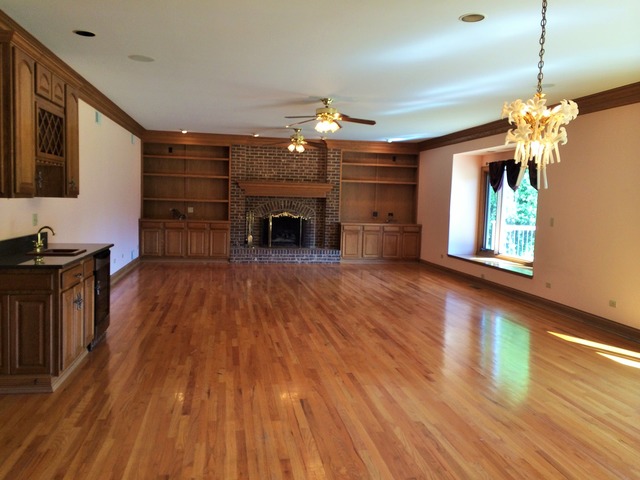 988 Plum Tree Road Fox River Grove, IL 60021 - Photo 4 of 25 a view of a livingroom with hardwood floor and a ceiling fan
