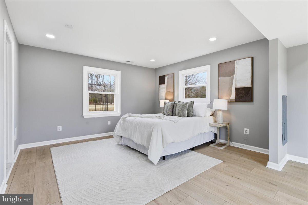15810 Letcher Road Brandywine, MD 20613 - Photo 15 of 50 a spacious bedroom with a large bed and a window