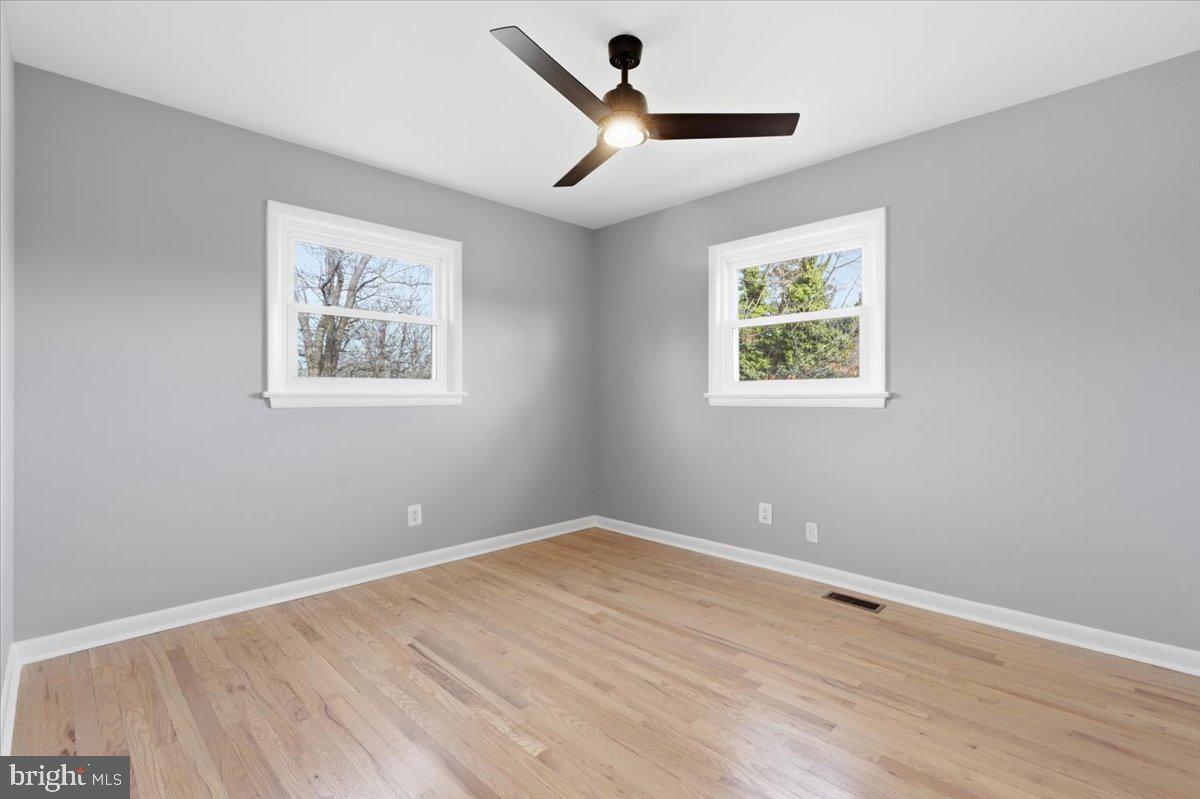 15810 Letcher Road Brandywine, MD 20613 - Photo 36 of 50 a view of an empty room with a window and a ceiling fan