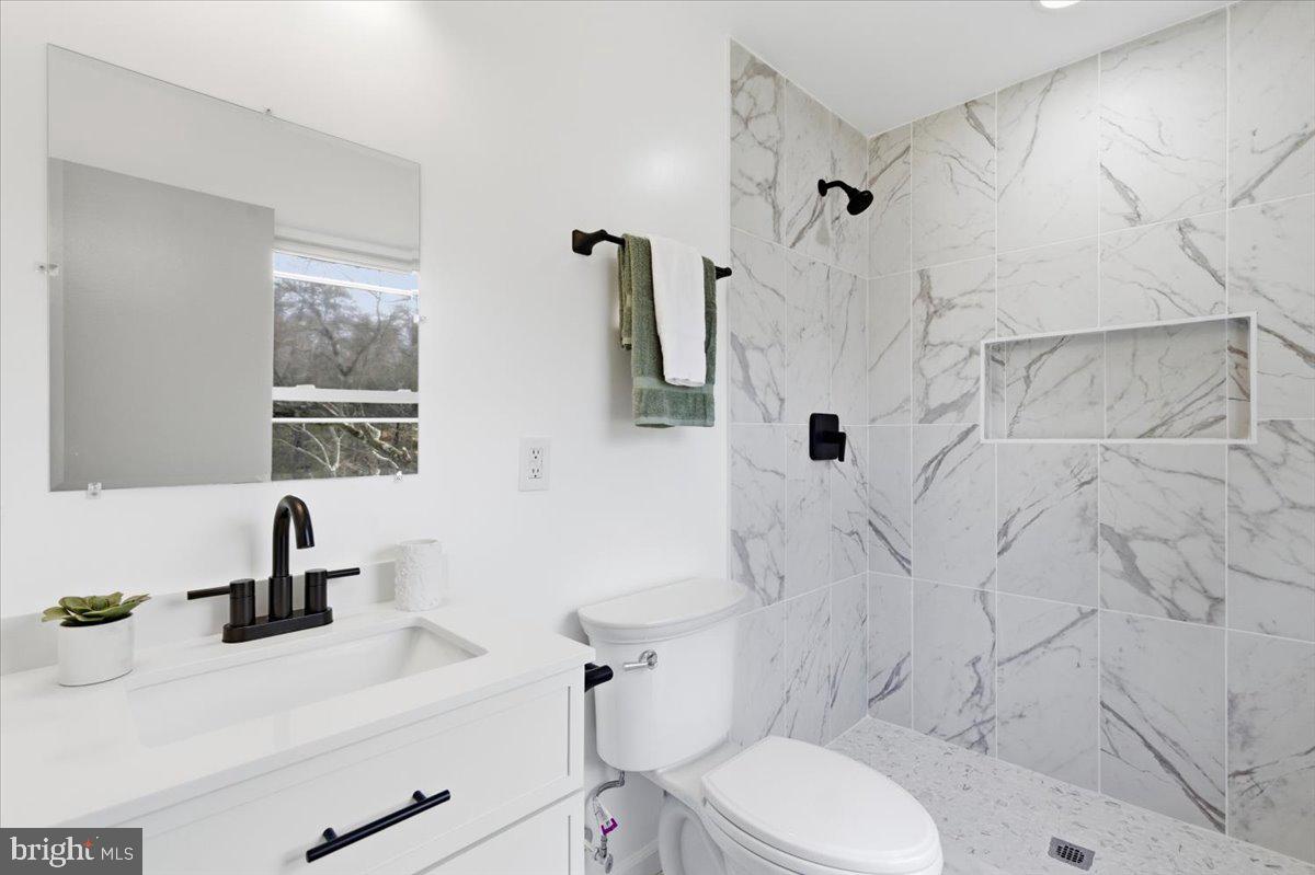 15810 Letcher Road Brandywine, MD 20613 - Photo 40 of 50 a bathroom with a sink toilet a mirror and shower