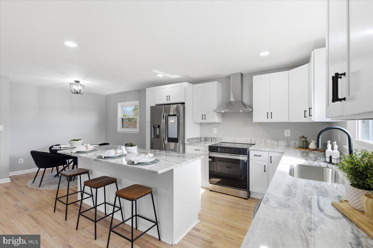 15810 Letcher Road Brandywine, MD 20613 - Photo 4 of 50 a kitchen with stainless steel appliances granite countertop a stove a sink dishwasher a stove a refrigerator with a dining table and chairs