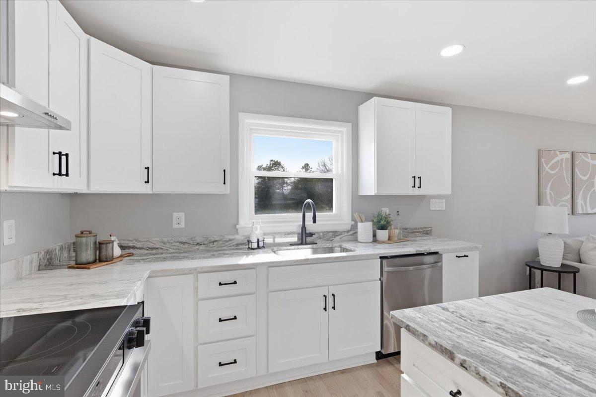 15810 Letcher Road Brandywine, MD 20613 - Photo 8 of 50 a kitchen with a sink dishwasher and cabinets with wooden floor