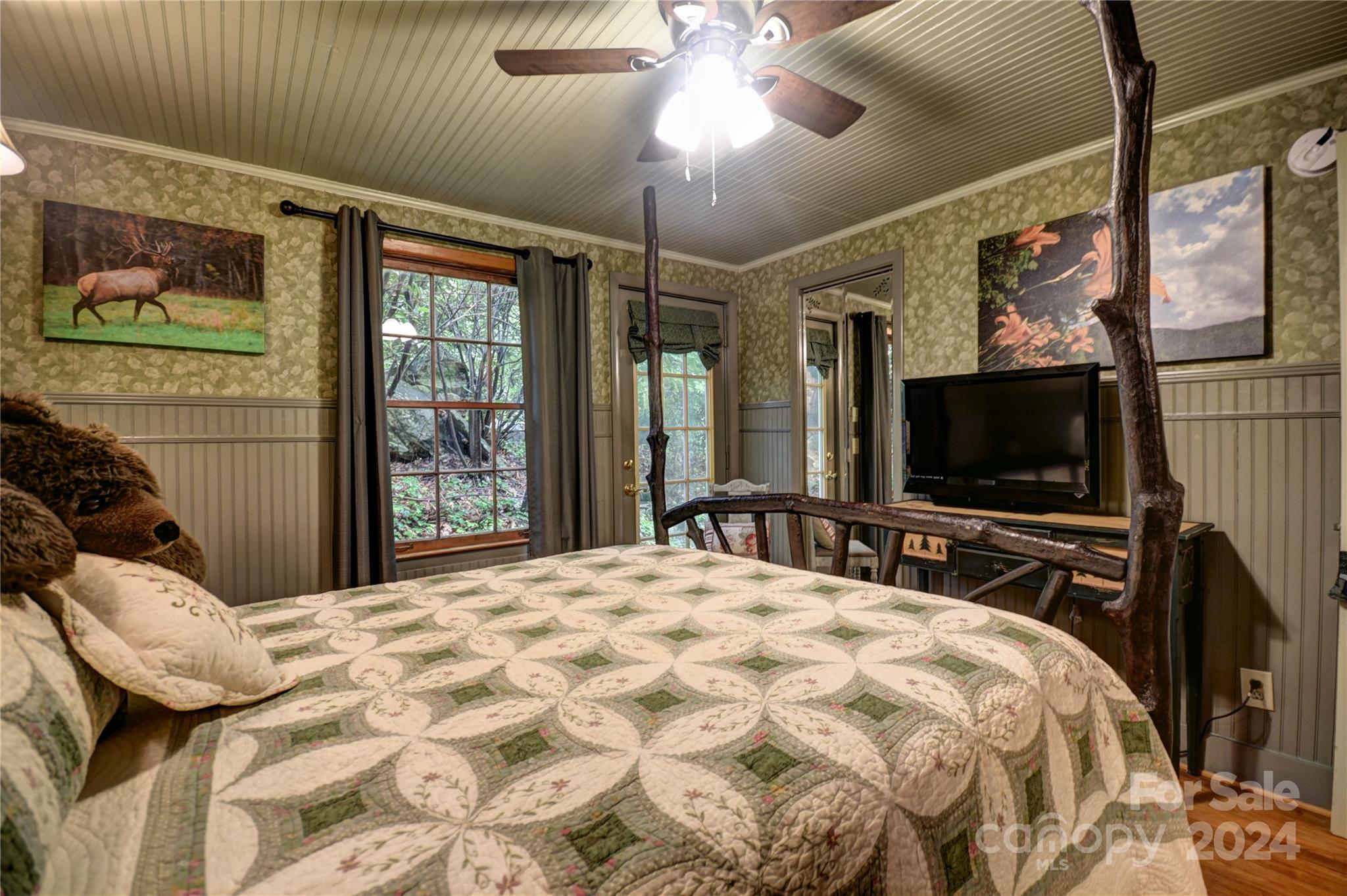 367 Johnson Branch Road Maggie Valley, NC 28751 - Photo 14 of 28 a bedroom with a bed and a flat screen tv