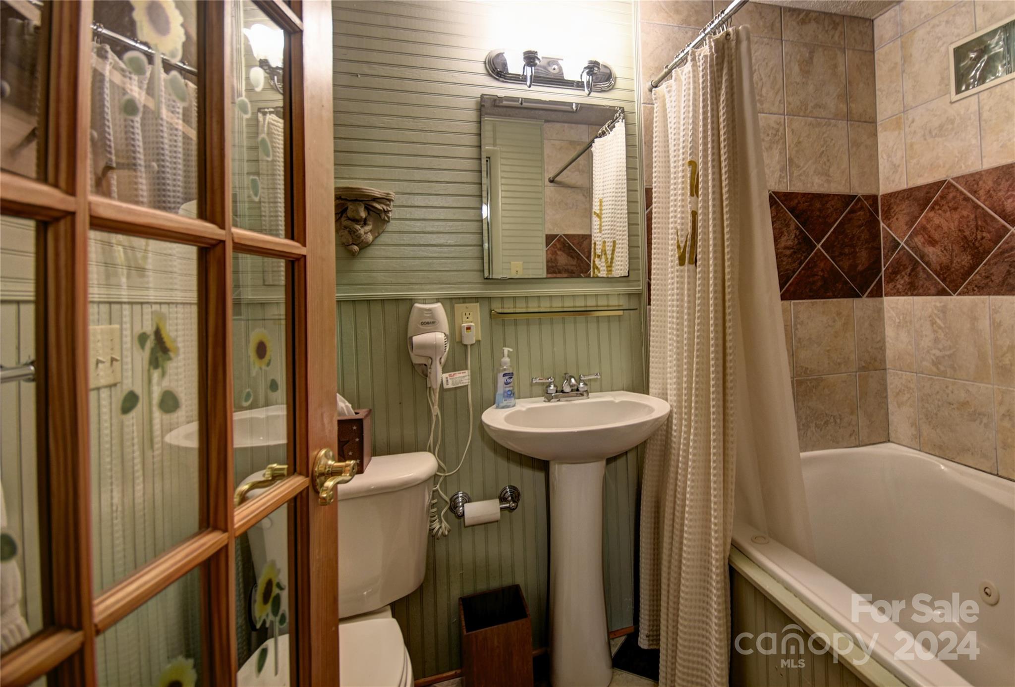 367 Johnson Branch Road Maggie Valley, NC 28751 - Photo 15 of 28 a bathroom with a sink and mirror