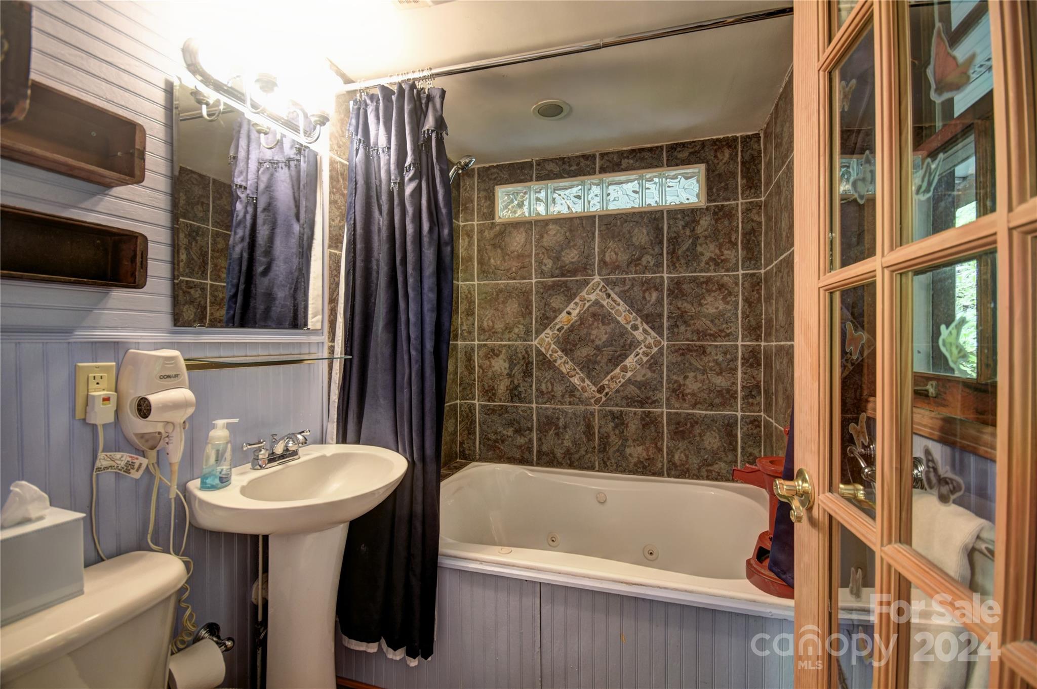 367 Johnson Branch Road Maggie Valley, NC 28751 - Photo 18 of 28 a bathroom with a sink toilet and shower