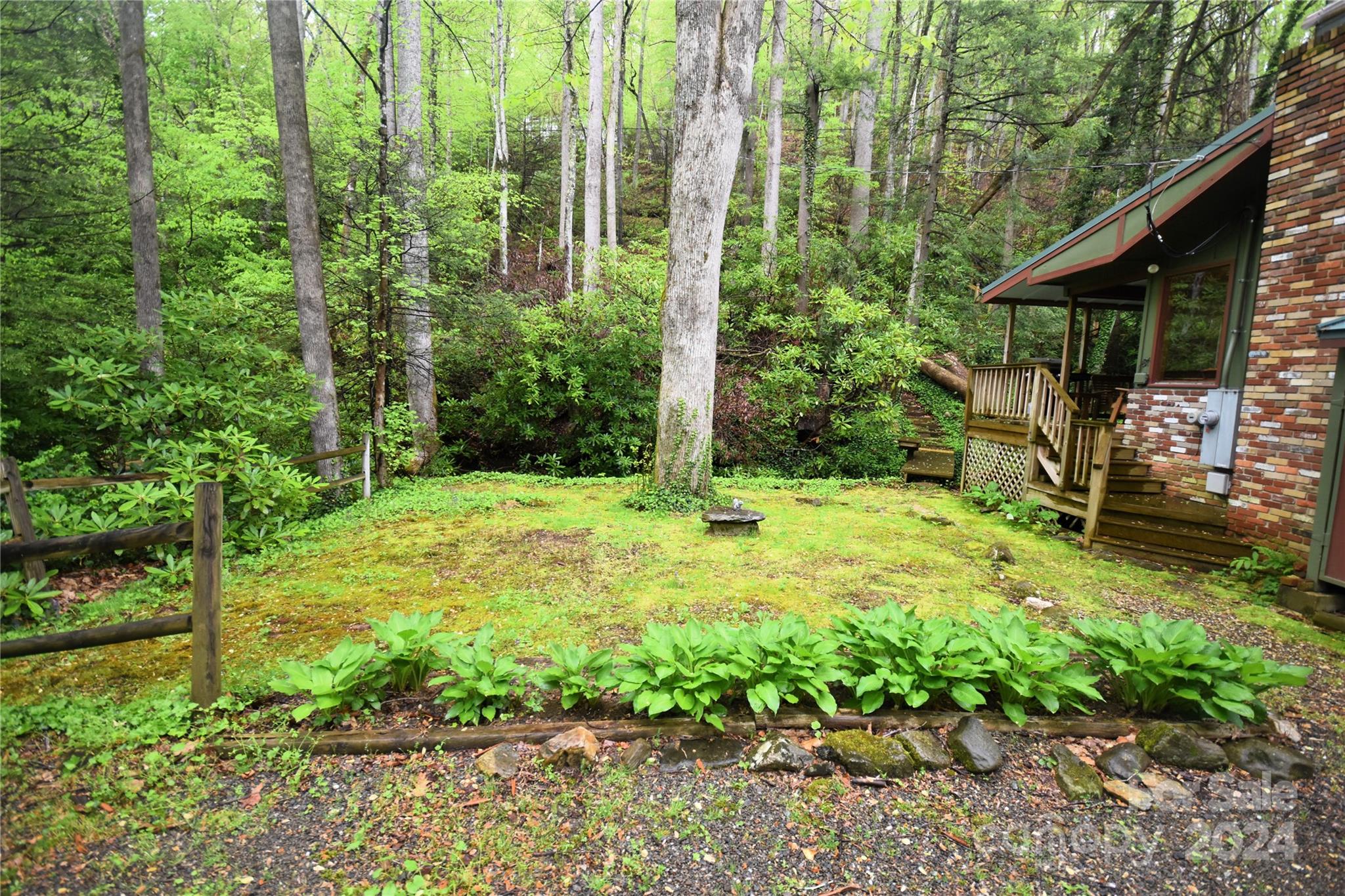 367 Johnson Branch Road Maggie Valley, NC 28751 - Photo 22 of 28 a view of a house with backyard and sitting area
