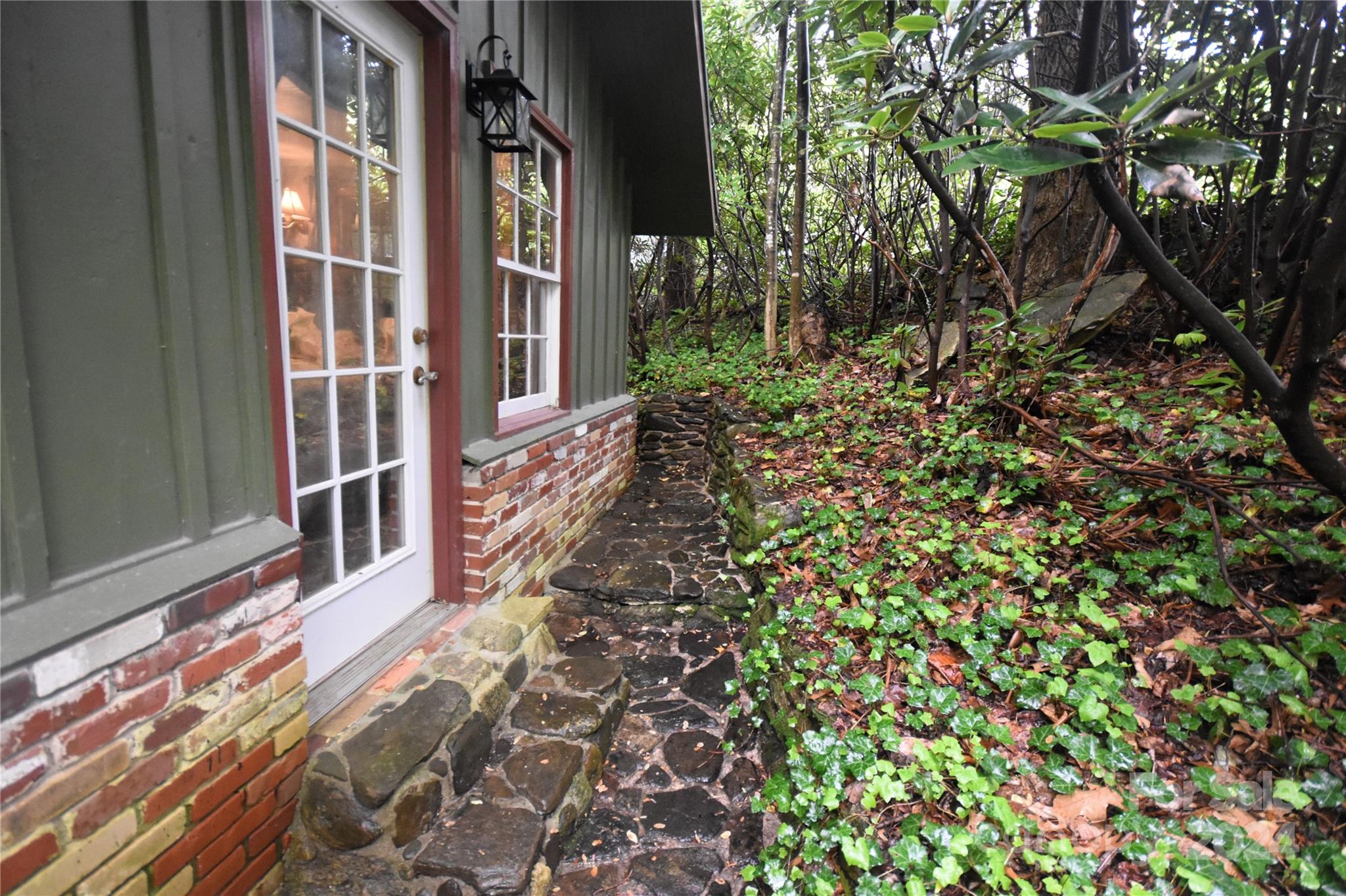 367 Johnson Branch Road Maggie Valley, NC 28751 - Photo 25 of 28 a view of a brick house with a small yard
