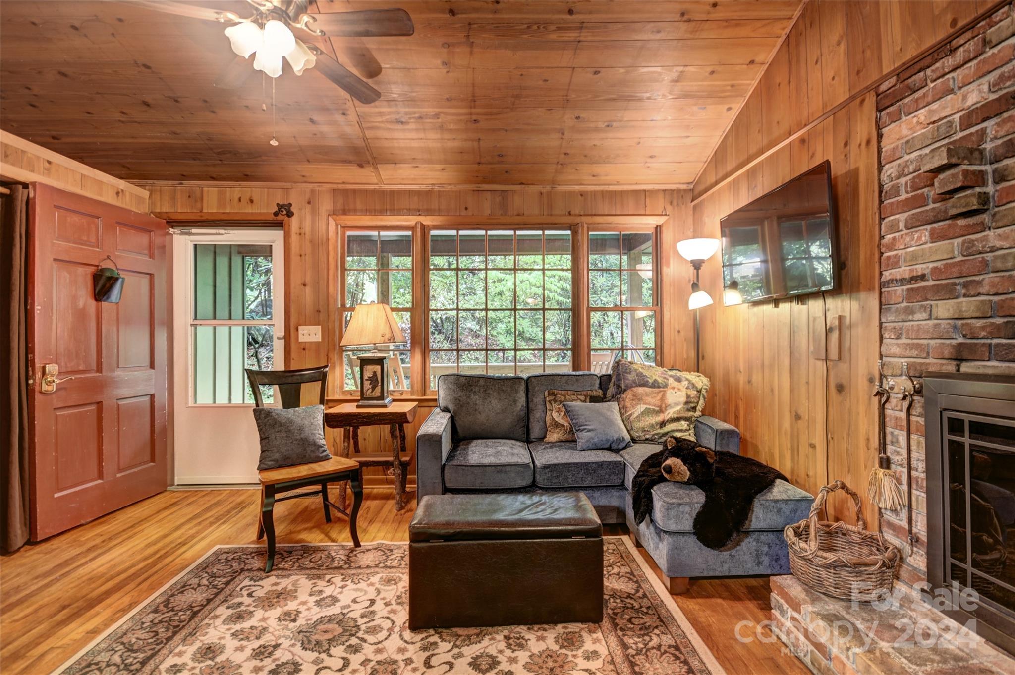 367 Johnson Branch Road Maggie Valley, NC 28751 - Photo 5 of 28 a living room with furniture and a fireplace